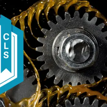 STLE-CLS logo “Certified Lubrication Specialist” next to metal gears coated with brown lubricating oil.